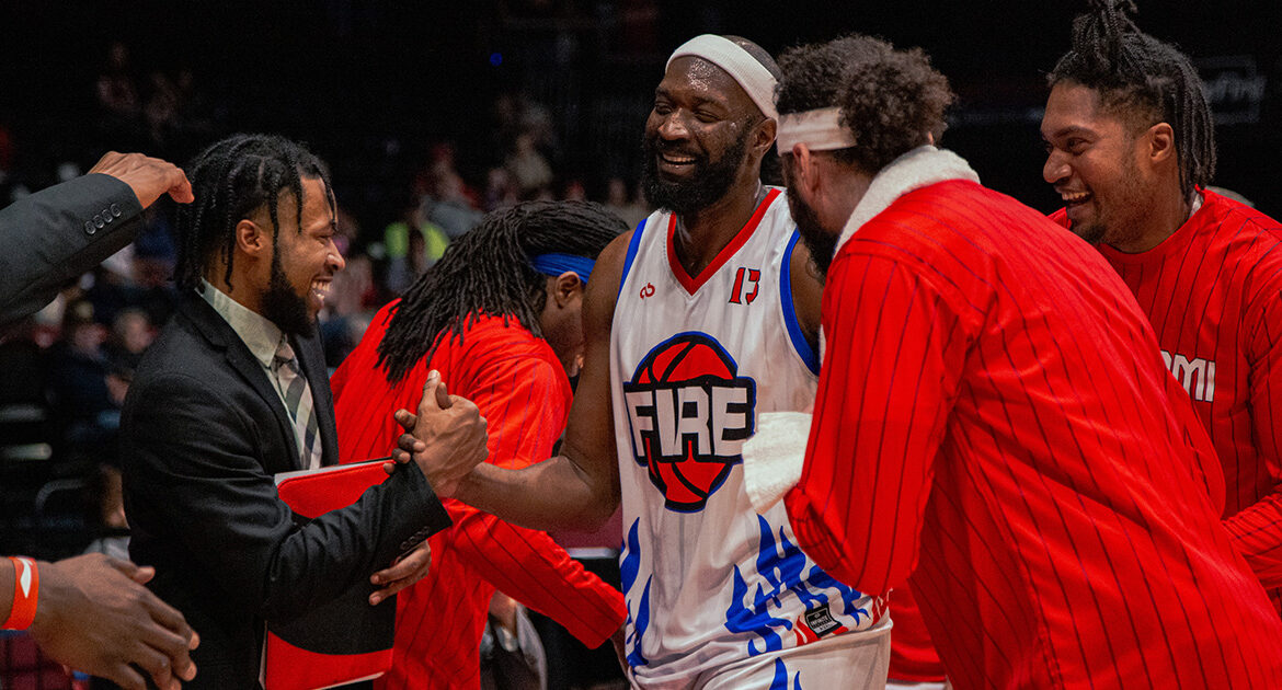 Chris Brand and company celebrate in the huddle