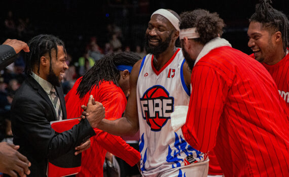 Chris Brand and company celebrate in the huddle