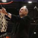 Coach Mark Dannhoff cuts down the net